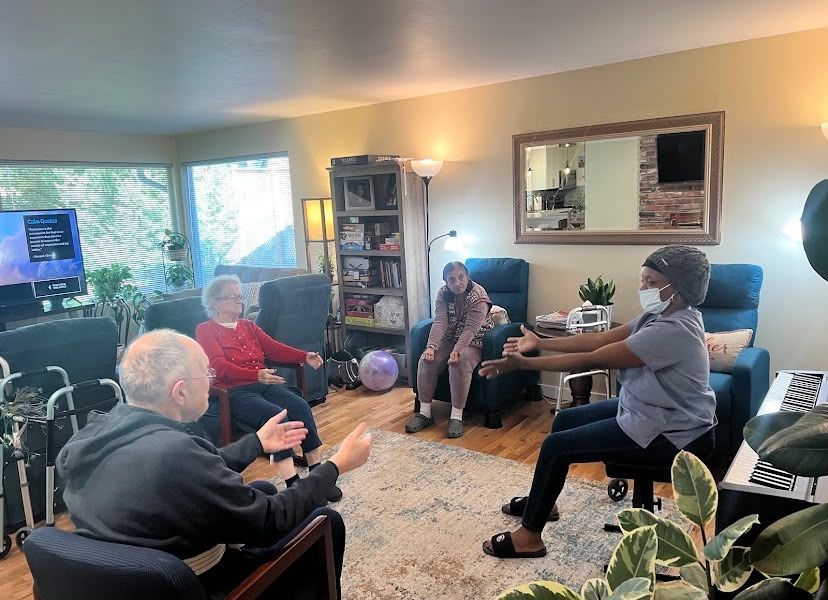 Residents enjoying an activity at Elderly Wellness Adult Family Home