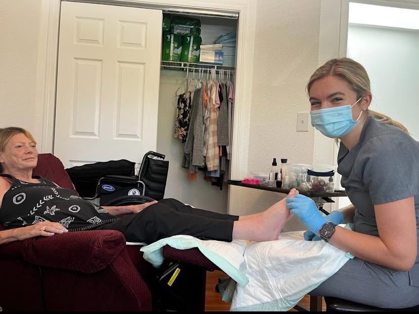 Caregiver assisting a resident at Elderly Wellness Adult Family Home in Bellevue WA