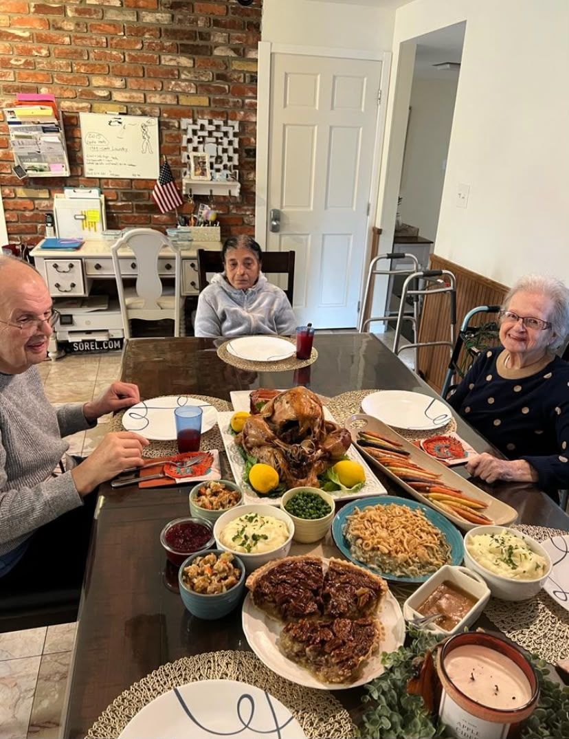 Residents enjoying a meal together at Elderly Wellness Adult Family Home Bellevue