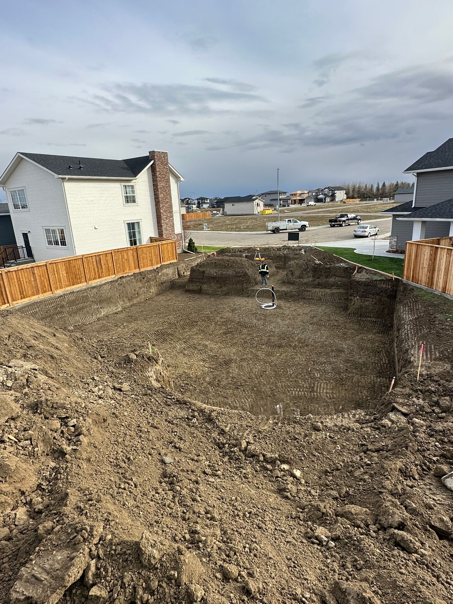 A large pile of dirt is sitting in front of a house.