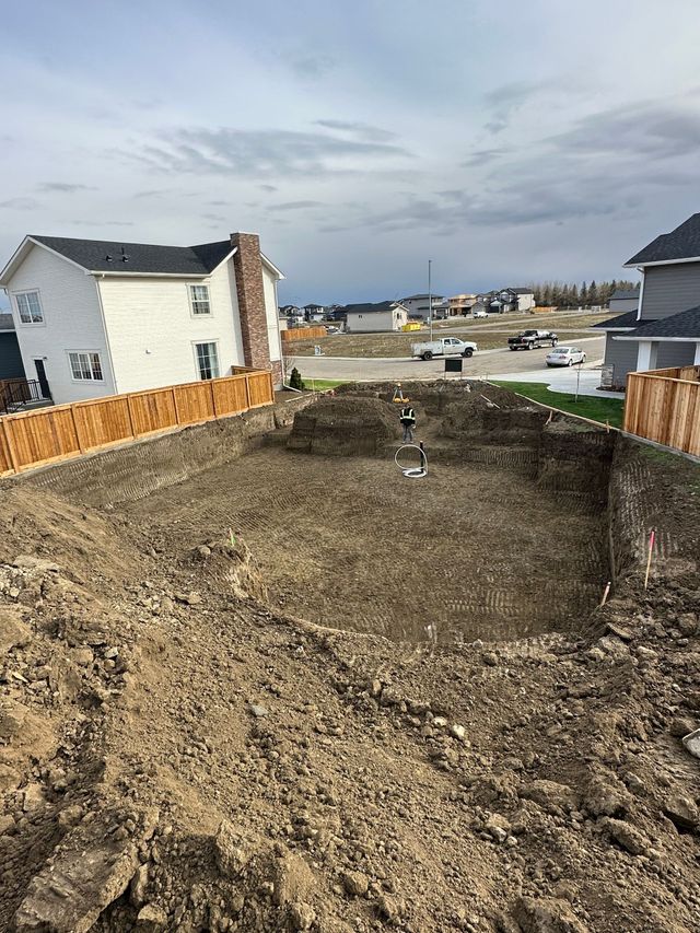 A large pile of dirt is sitting in front of a house.