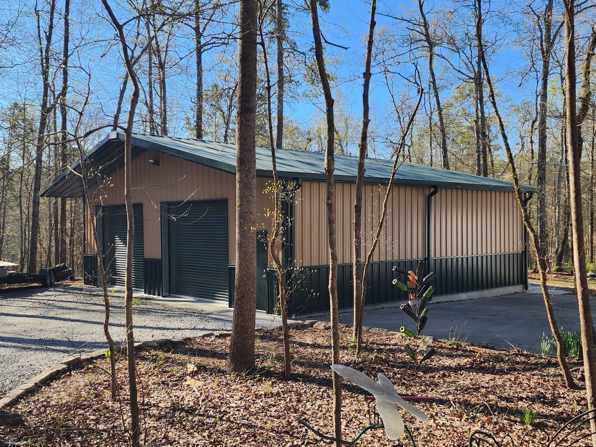 A garage is surrounded by trees in the middle of a forest.
