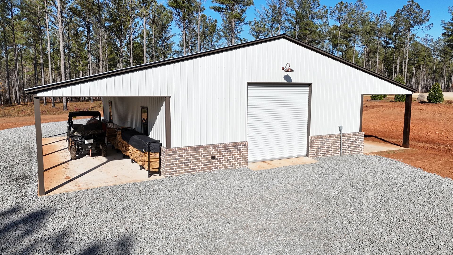 A white garage with a car parked underneath it