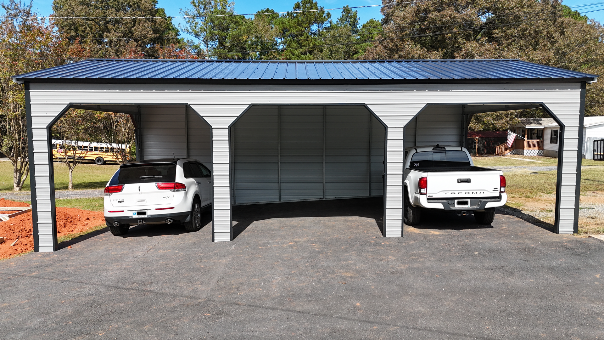 Metal carport with a white SUV and a white pickup truck parked underneath.