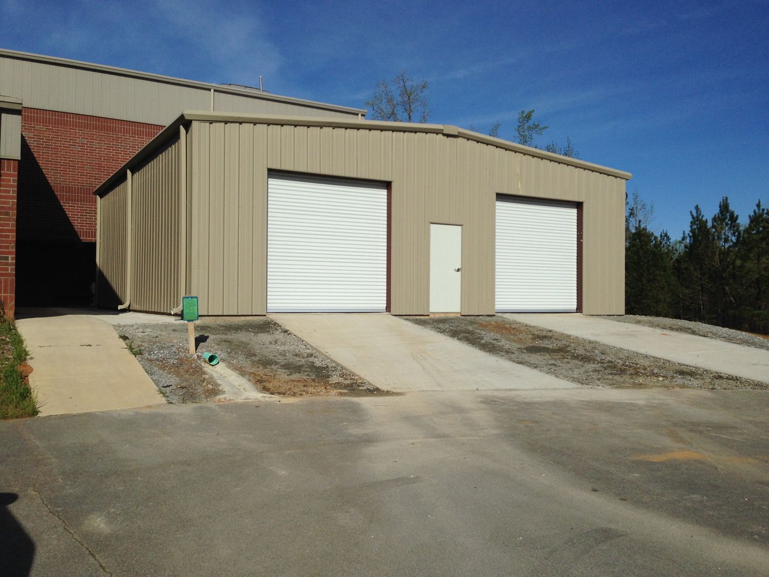 A garage with two white garage doors and a white door