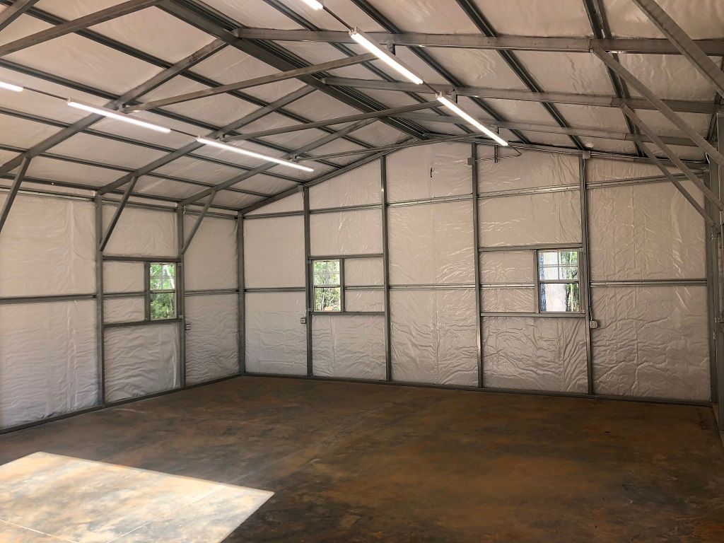 A large empty building with foam insulation on the walls and ceiling.