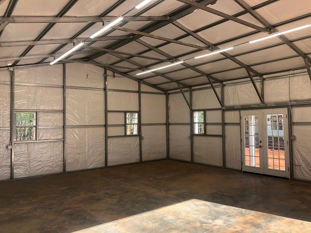 A large empty room with a door and windows.