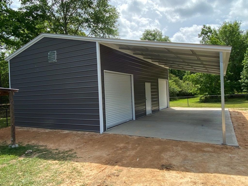 A garage with a canopy over it and a trash can in front of it.