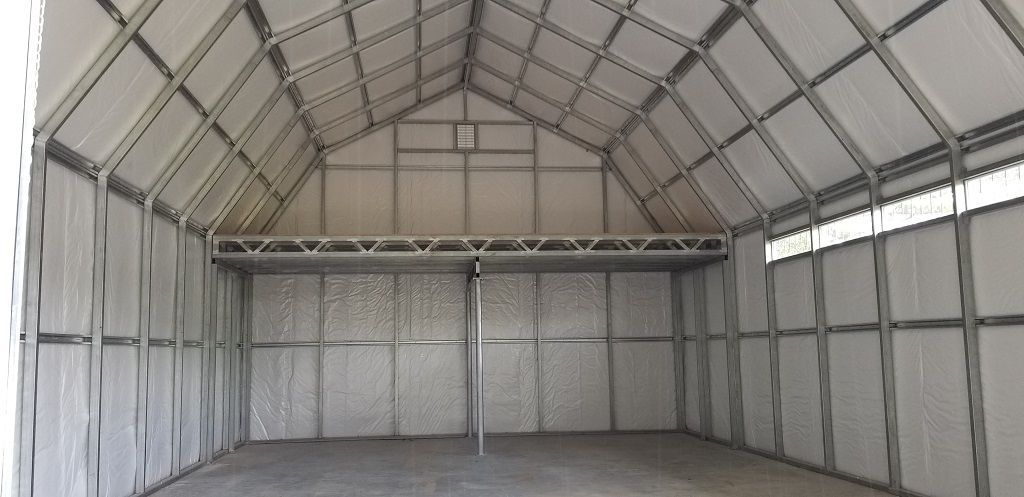 The inside of a large warehouse with a vaulted ceiling.