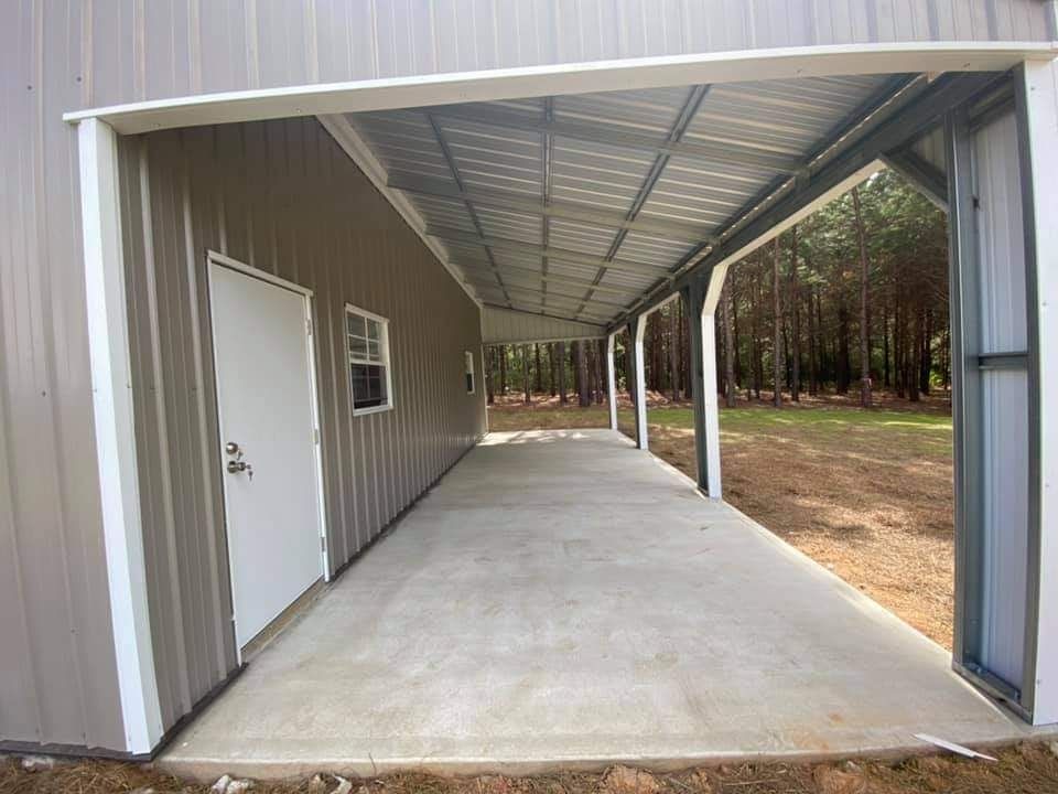 A large metal building with a covered walkway leading to it.