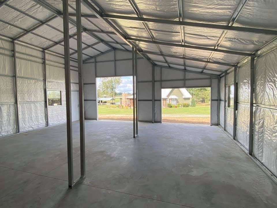 A large empty building with a lot of windows and doors.