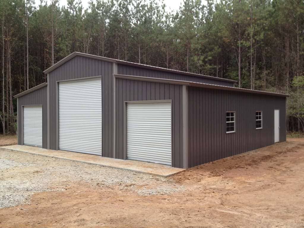 A large metal building with a lot of windows and garage doors