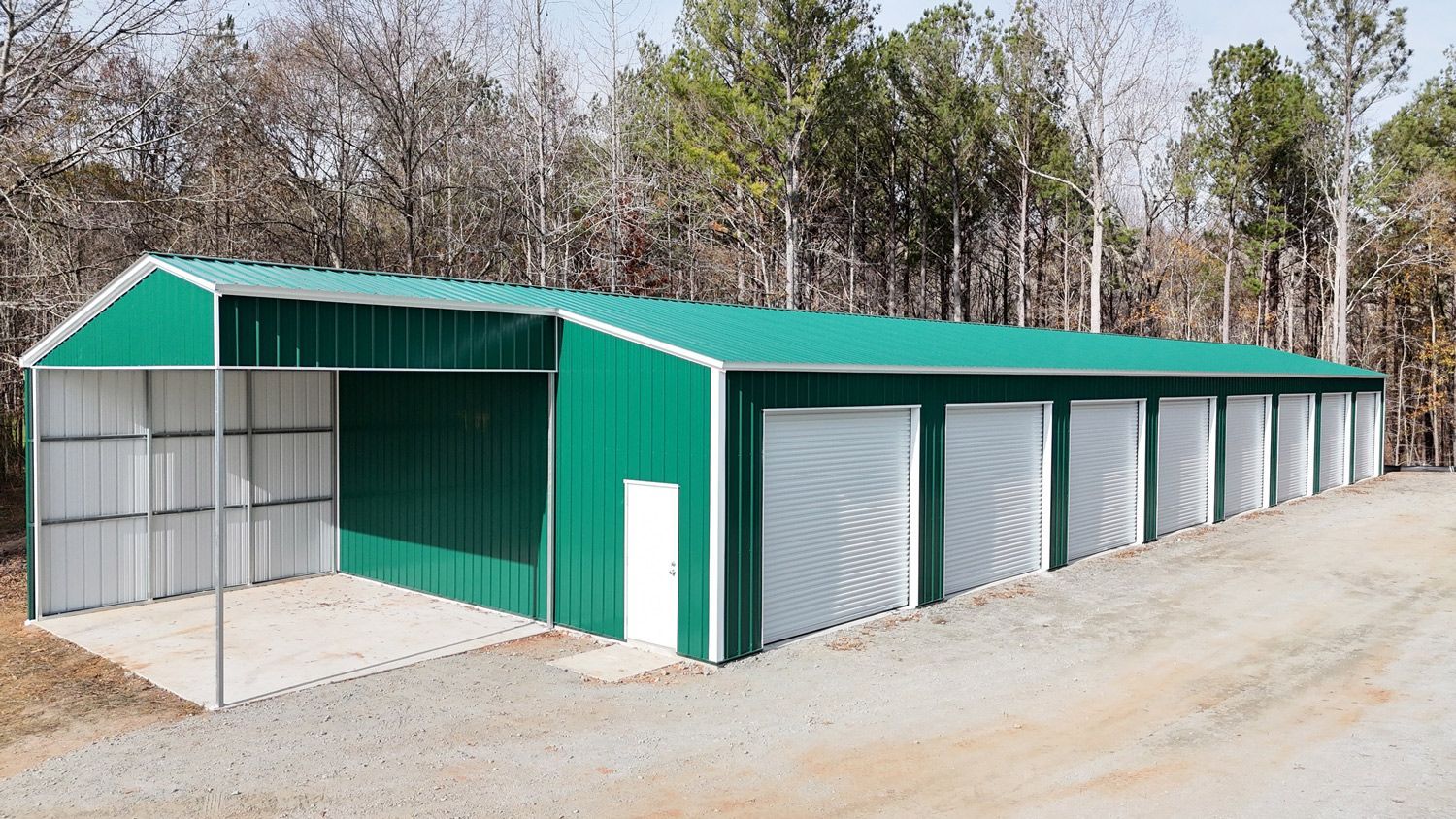 A green and white building with a lot of garage doors