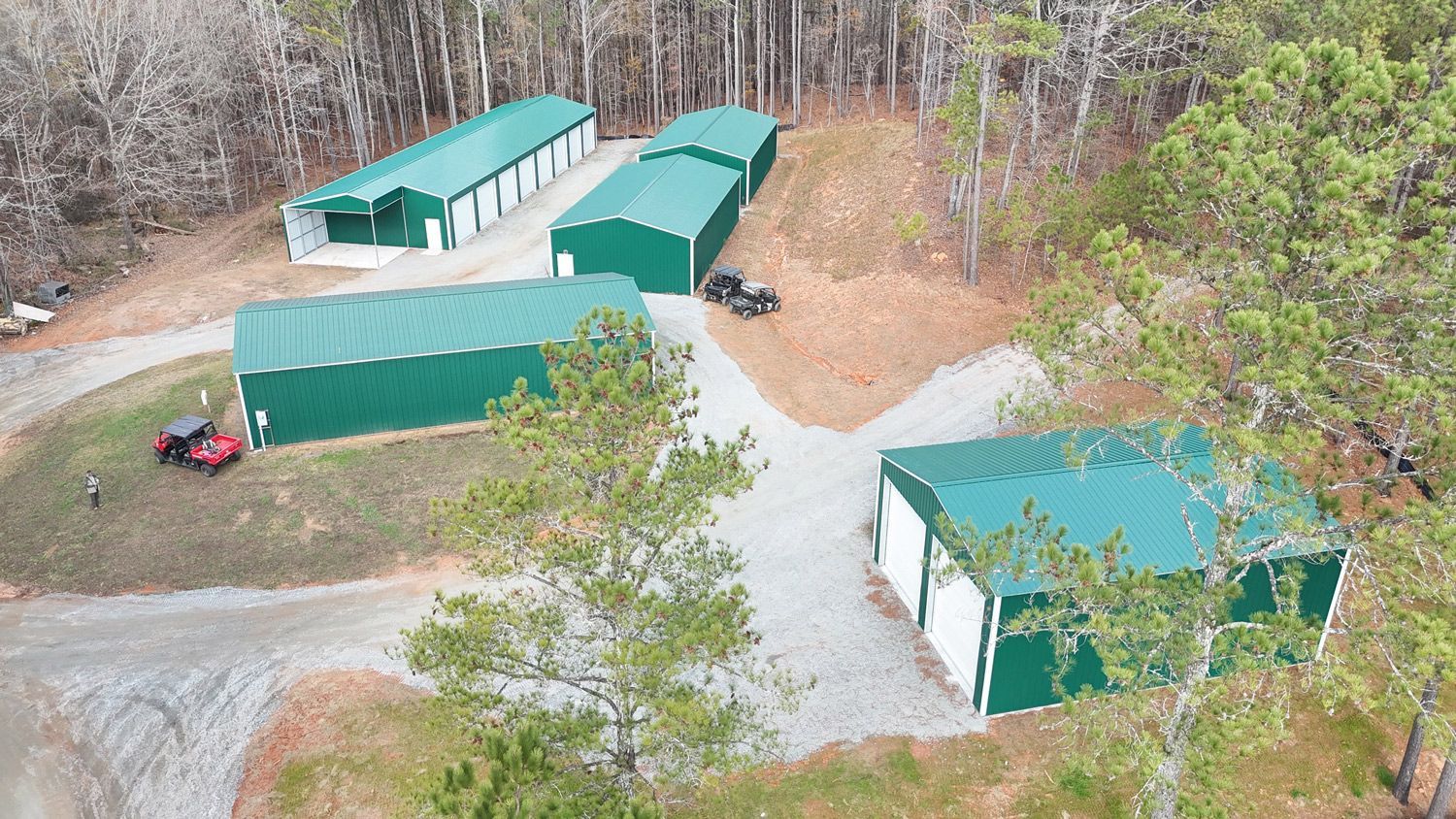 An aerial view of a storage facility in the middle of a forest.