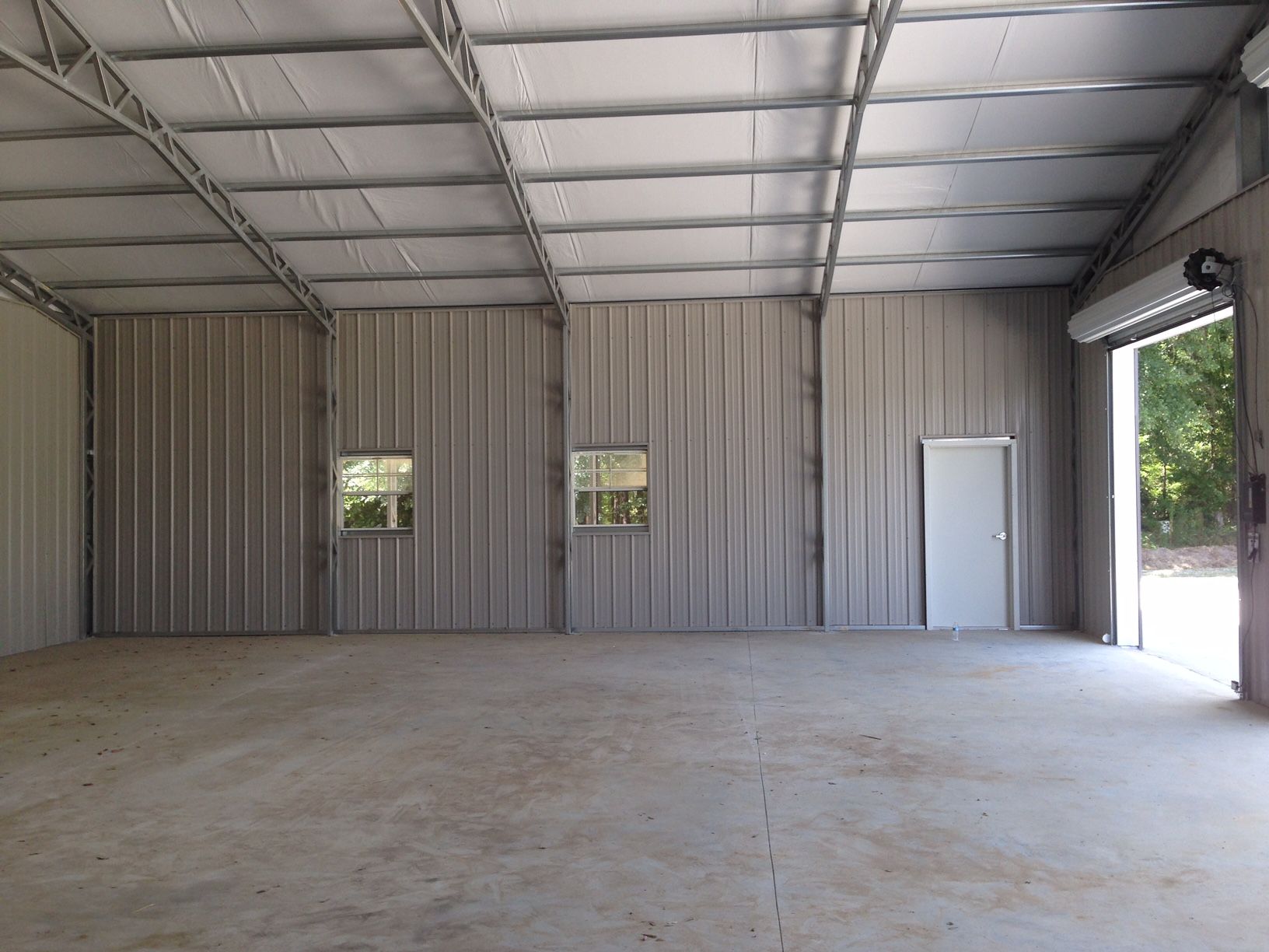 A large empty building with a door and windows