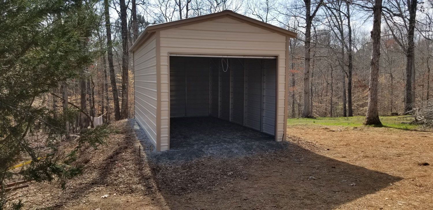 A small garage is sitting in the middle of a forest.