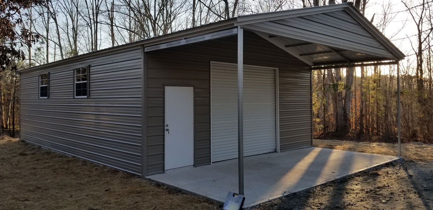 A metal garage with a porch and a garage door.