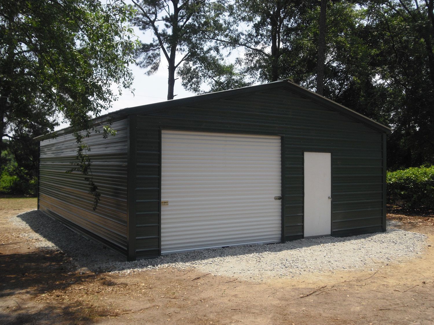 A black garage with a white door and a white garage door