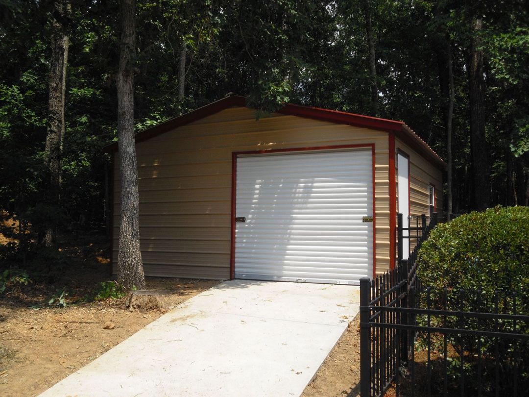 A garage with a concrete driveway leading to it