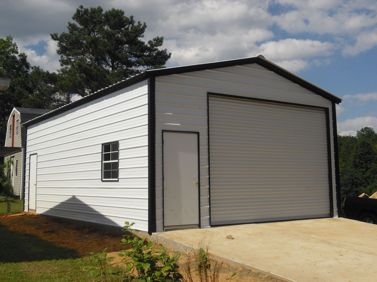 A white garage with a garage door and a window