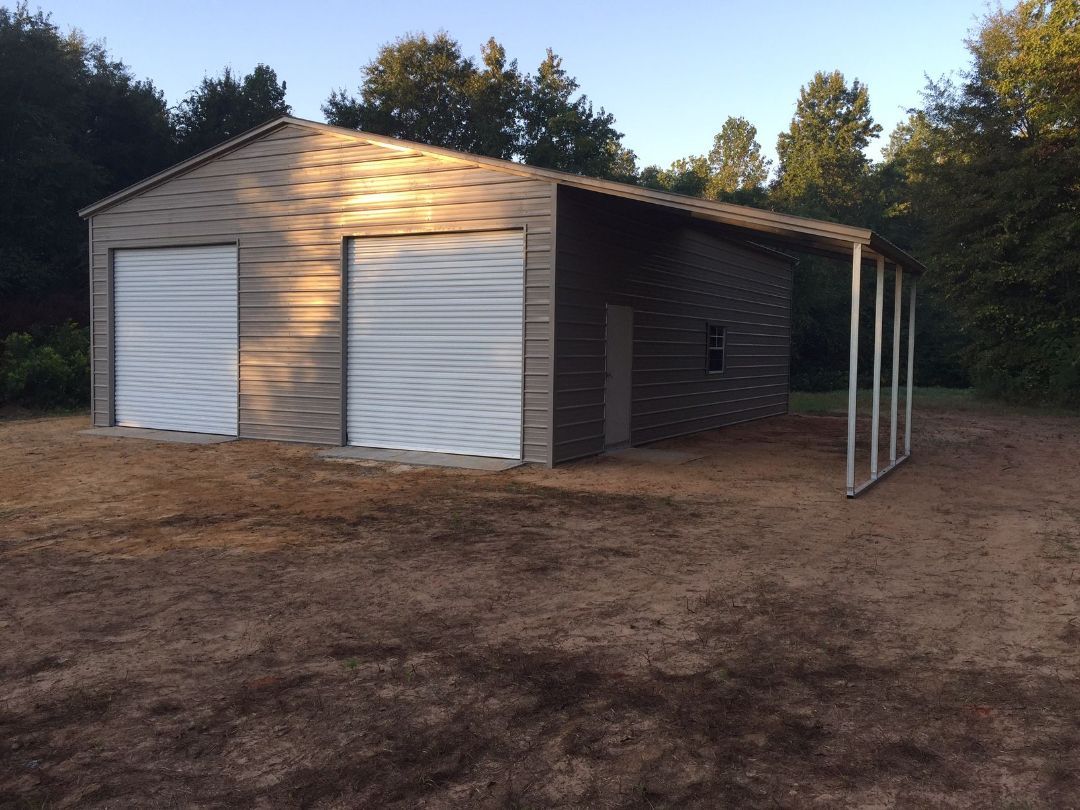 A garage with two white doors and a porch