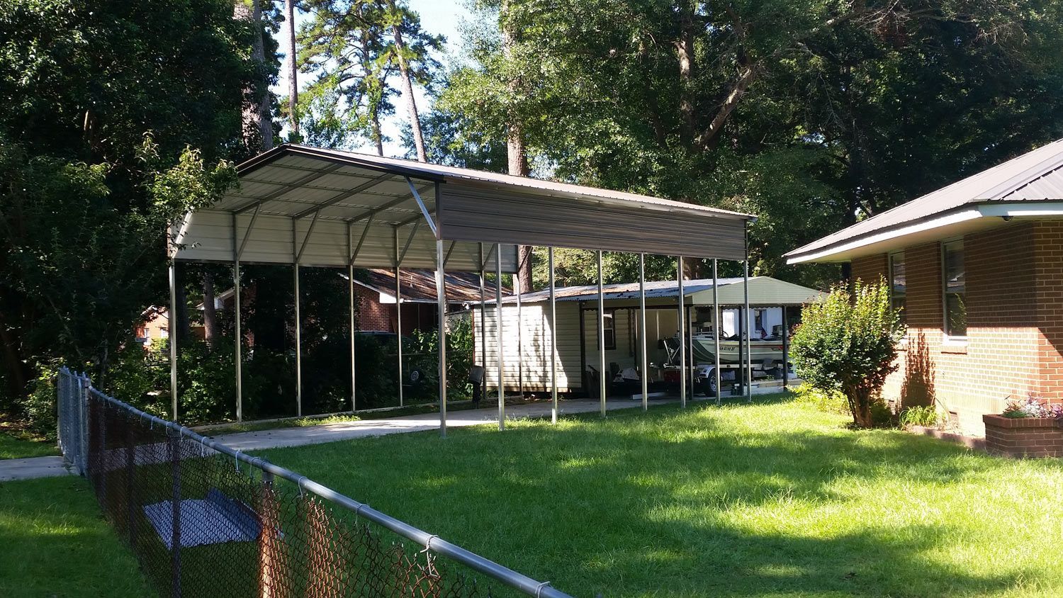 There is a carport in the backyard of a house.