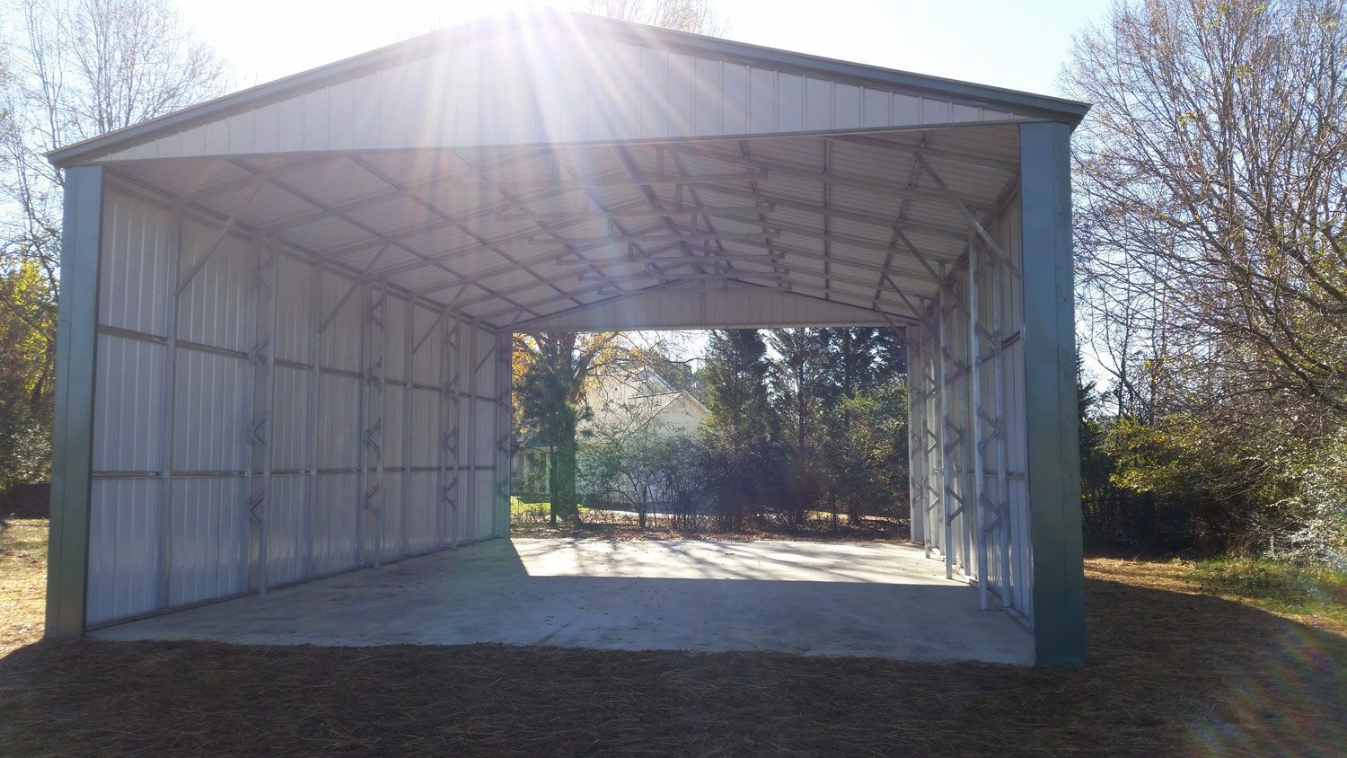 The sun is shining through the roof of a metal building.