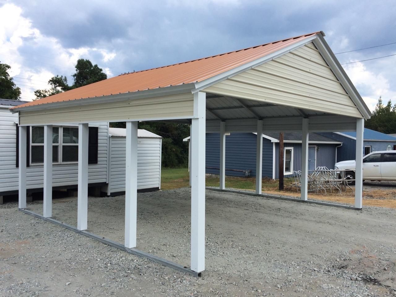 A carport with an orange roof is in front of a house.