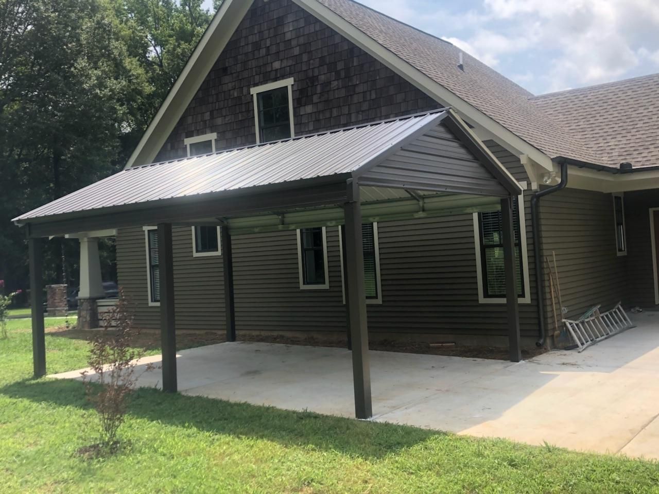 A house with a covered porch on the side of it.