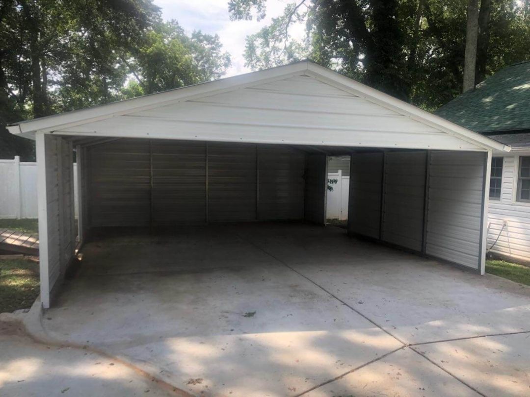 There is a carport in the backyard of a house.
