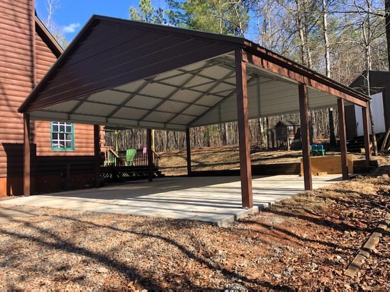 There is a carport in the backyard of a house.