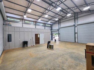 A large warehouse with a lot of windows and a box on the floor.