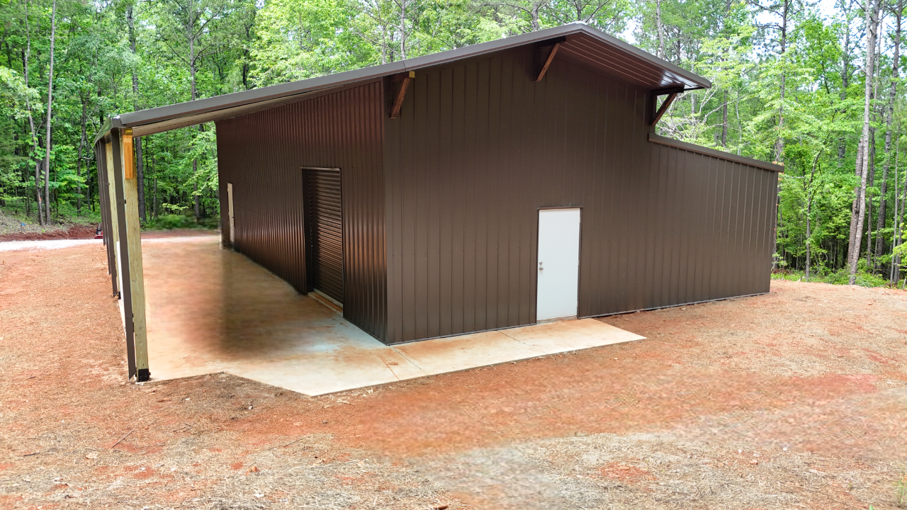 A brown metal building with a white door is sitting on top of a dirt hill.