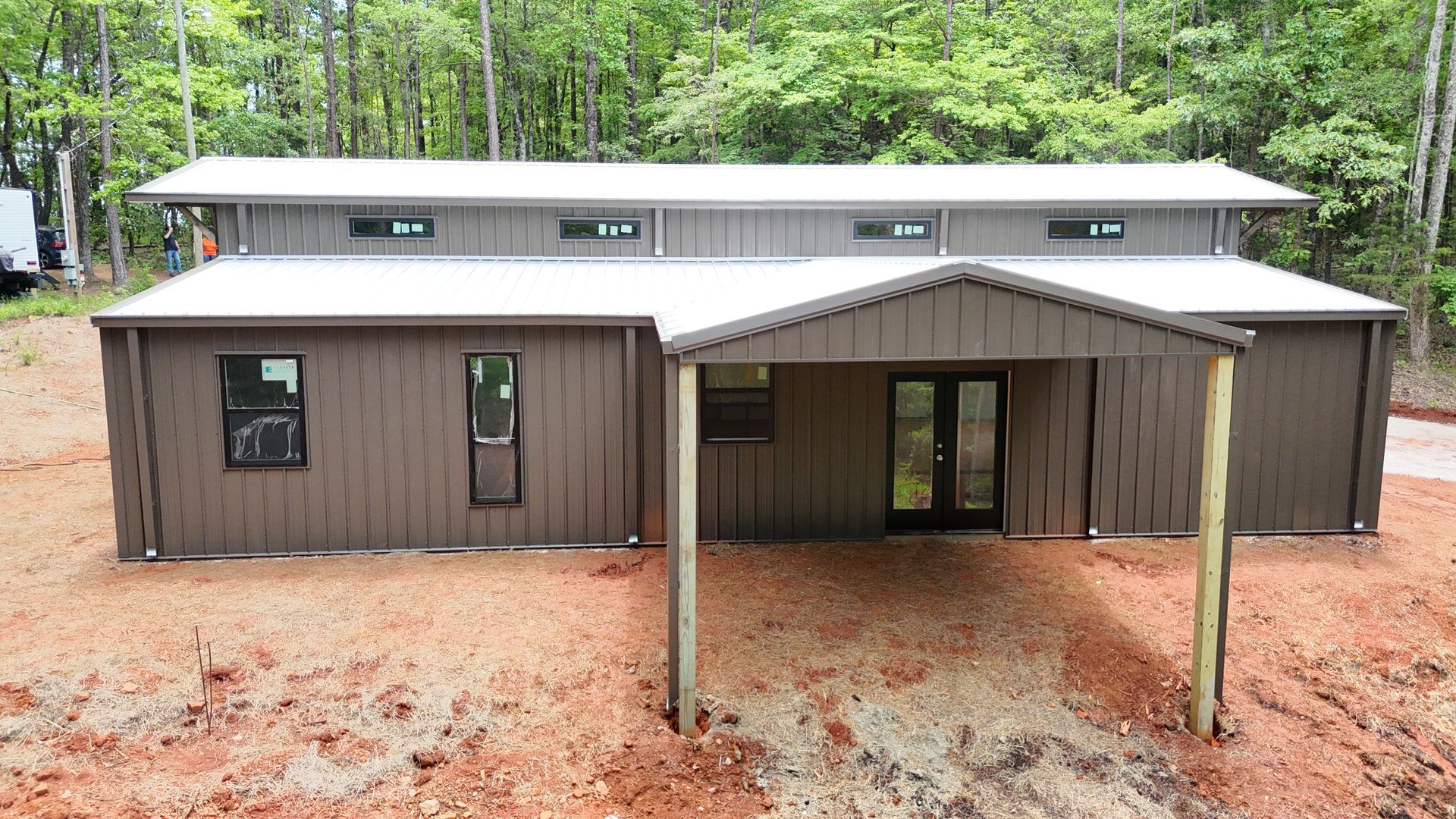 A large metal building with a carport in front of it.