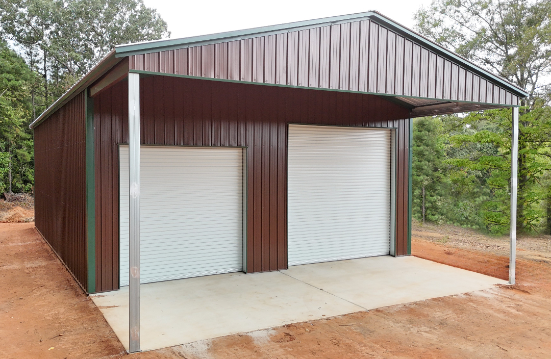 Brown and green steel garage with two white roll-up doors and a carport extension.