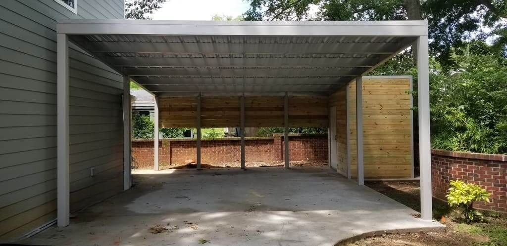 A carport is being built in the backyard of a house.