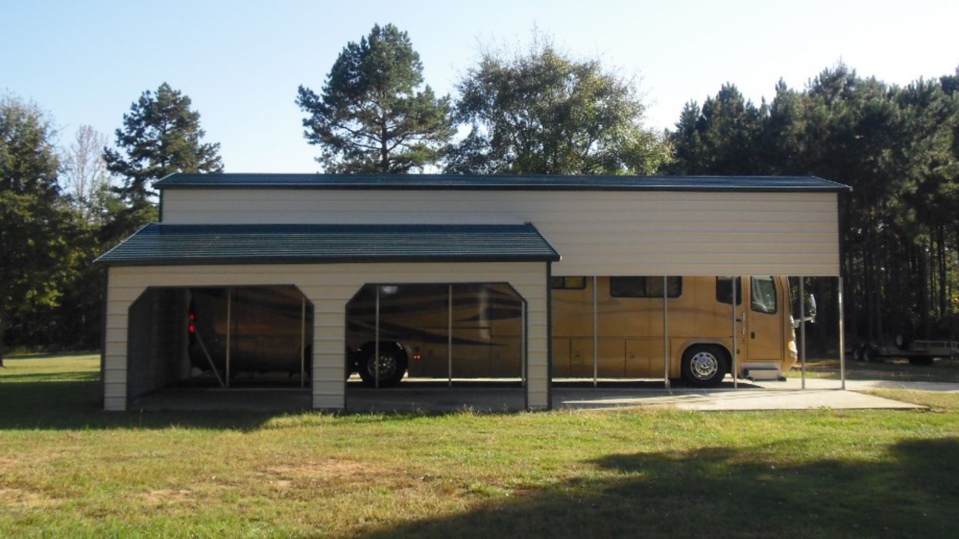 A rv is parked under a carport with trees in the background