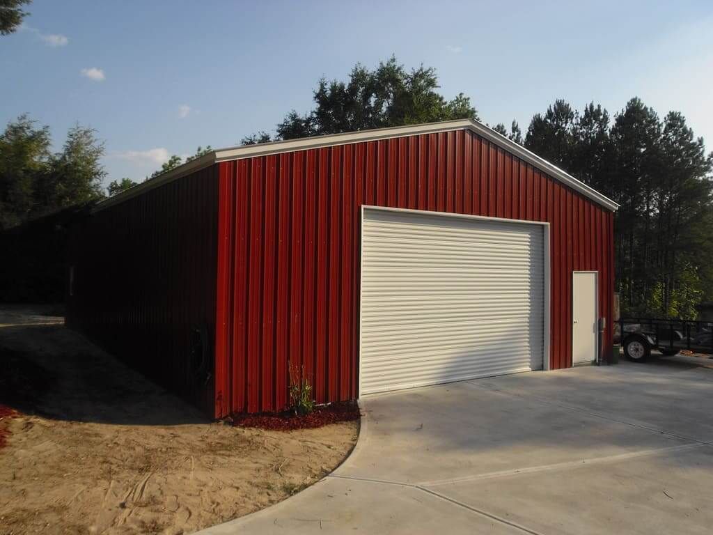 A red and white garage with a white door