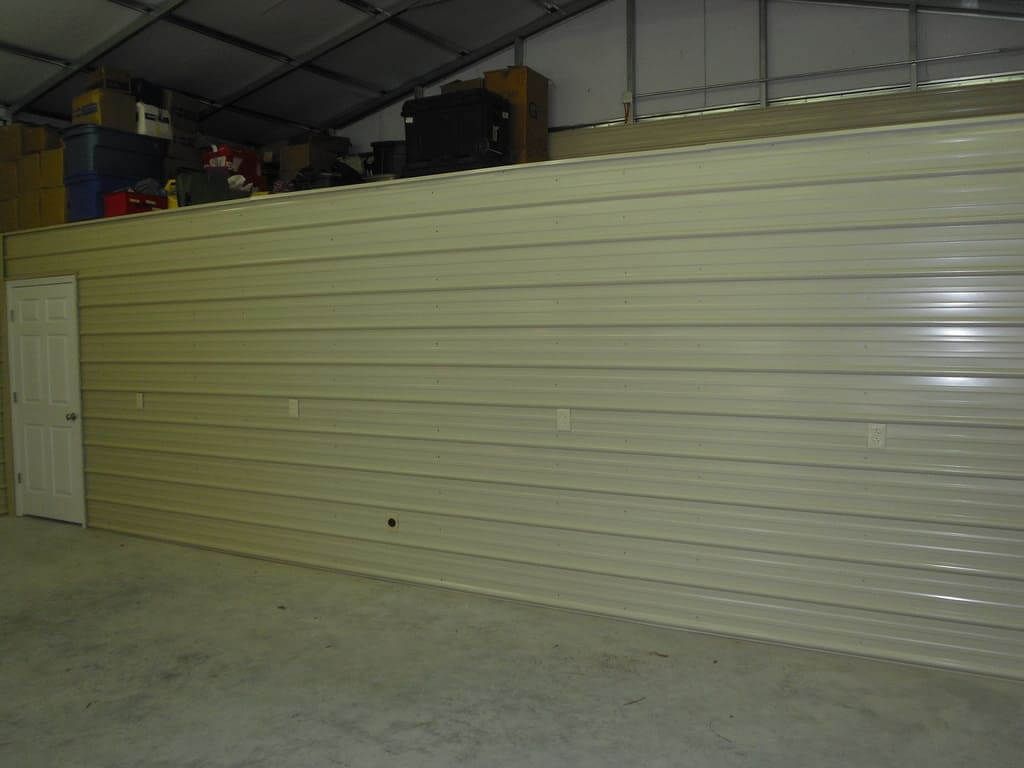 An empty garage with a large wall and a door