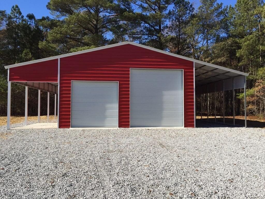 A red and white garage with a carport underneath it