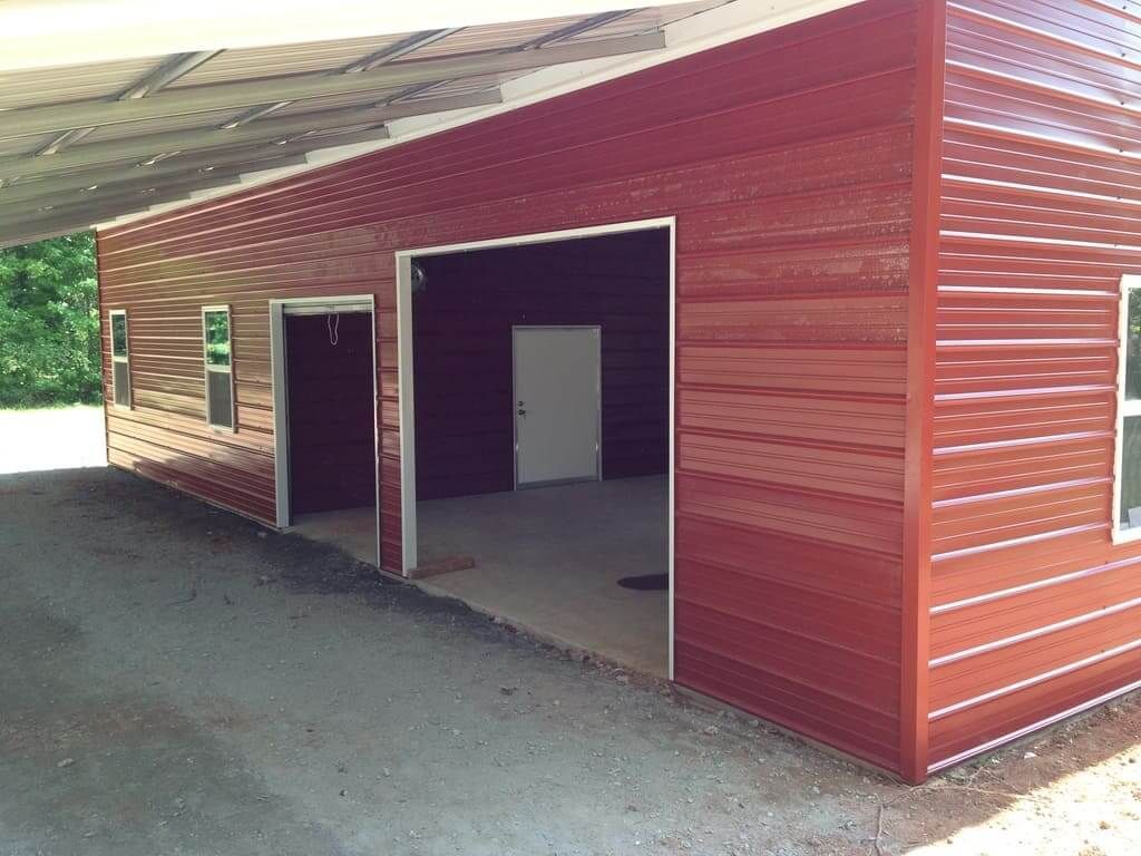 A red garage with a white door and windows