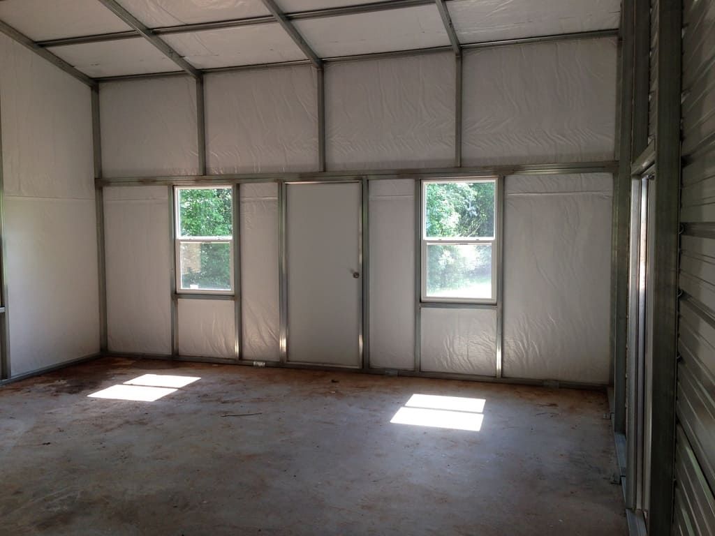 An empty room with a lot of windows and doors