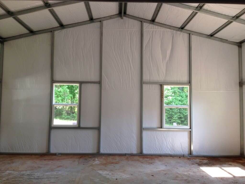 The inside of a building with white walls and windows.