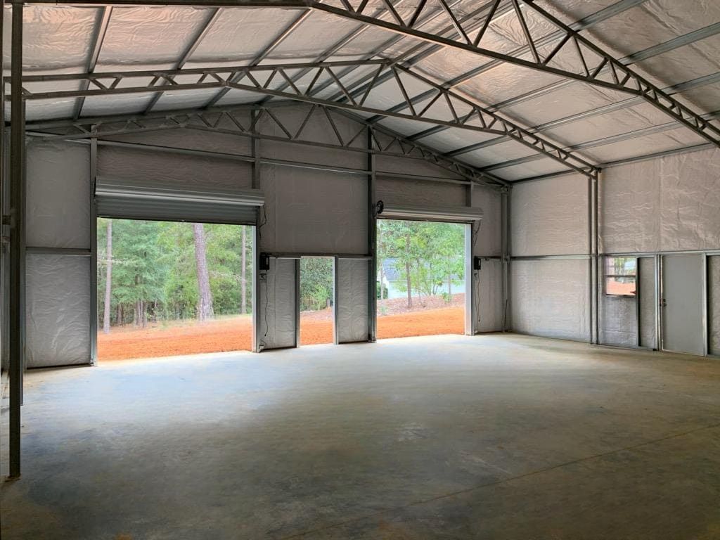 A large empty building with a lot of windows and doors.