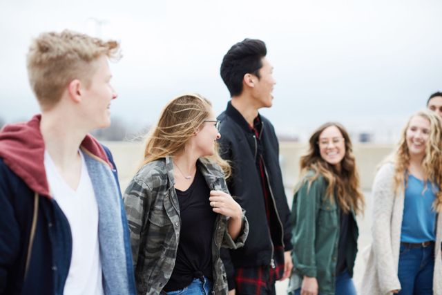 A group of young people are walking down a street.