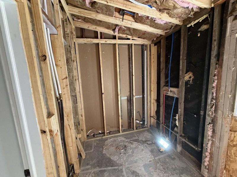 Framed bathroom with plumbing rough-in complete and ready for inspection