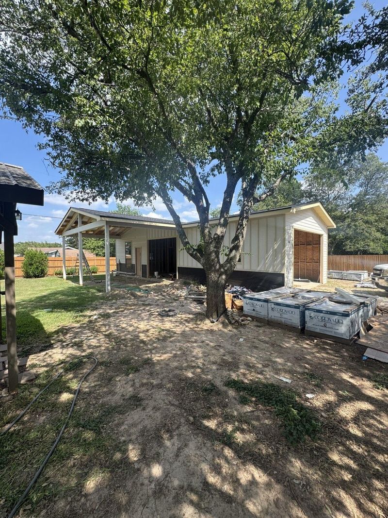 Covered outdoor structure under construction in a backyard