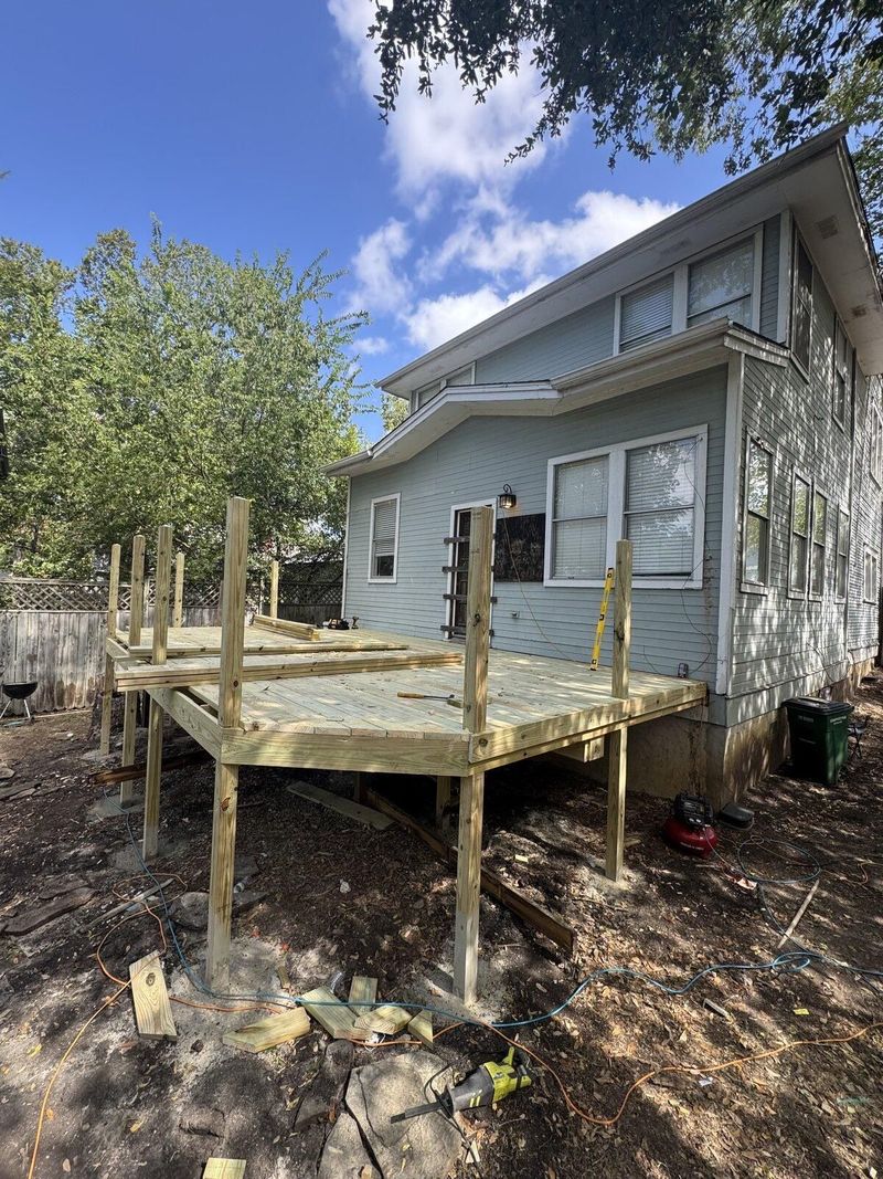 New deck framing under construction at a two-story home renovation