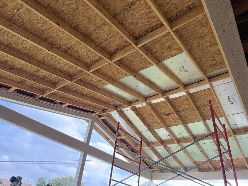 New roof framing over a porch addition under construction in Austin