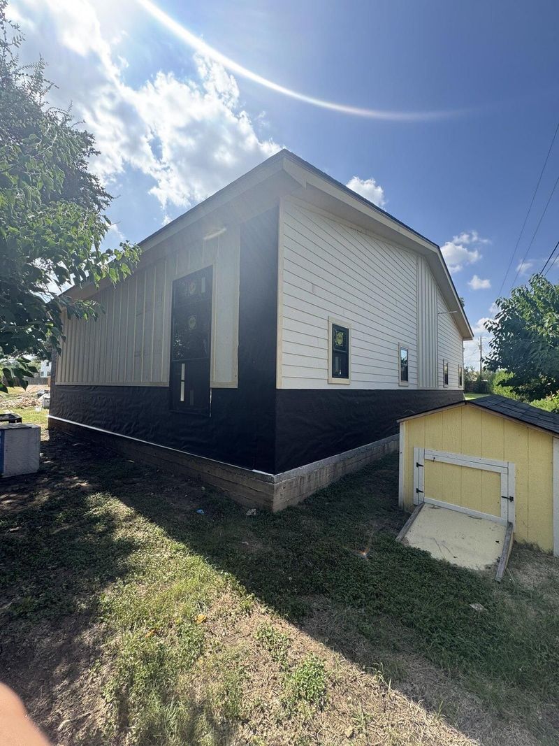 Detached structure with new siding and exterior finish work complete